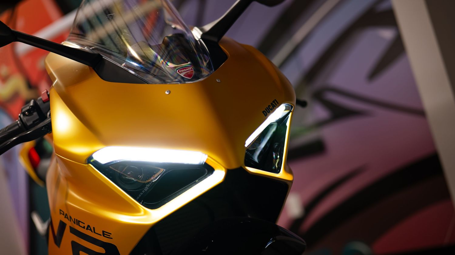 Abstract view of motorcycle bodywork with reflective surfaces and sharp angles.