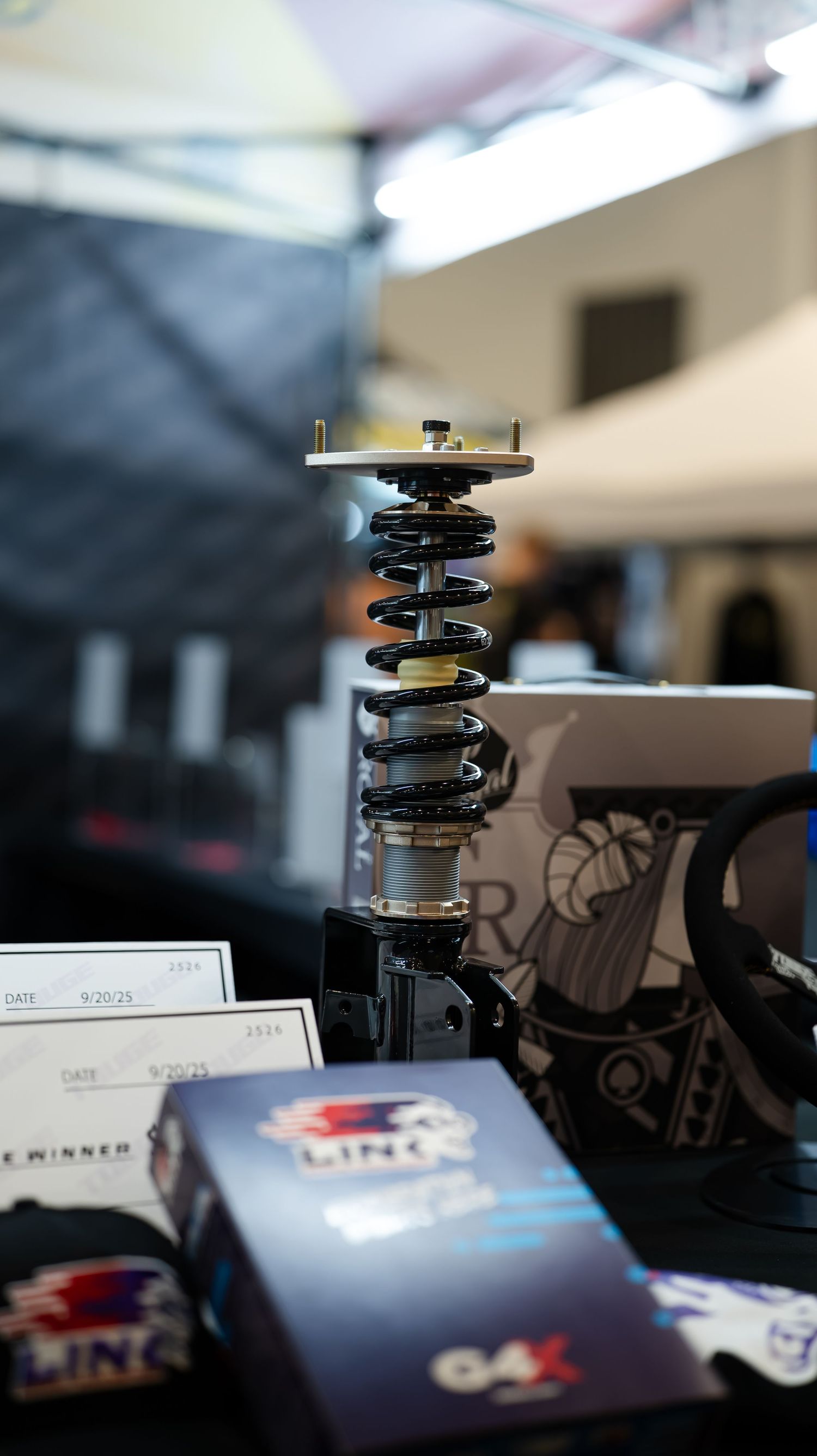 Close-up of car suspension coils and automotive parts on a display.