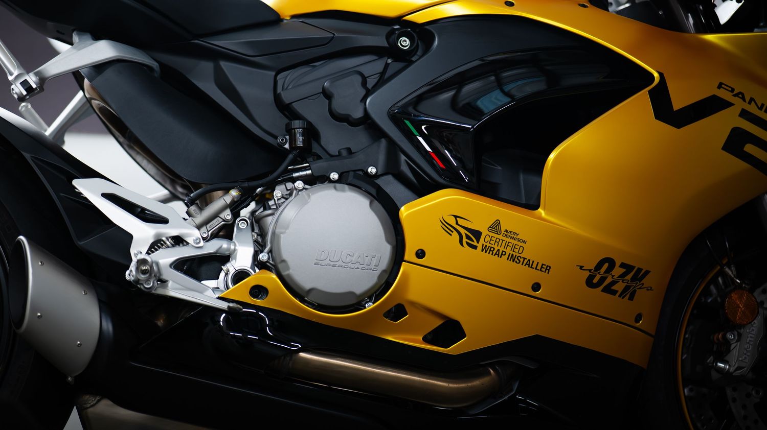 Yellow Ducati motorcycle body panels shown in dramatic lighting.
