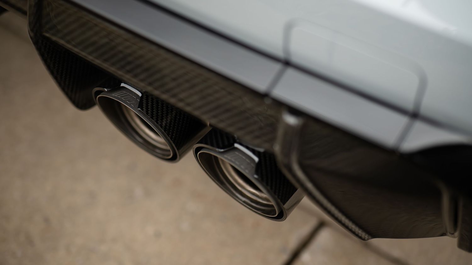 Dual black exhaust tips on a BMW performance vehicle.