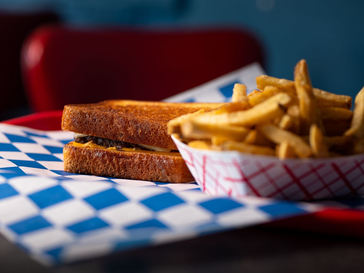 Classic diner-style grilled cheese sandwich with golden-brown toast and melted cheese served with crispy french fries.