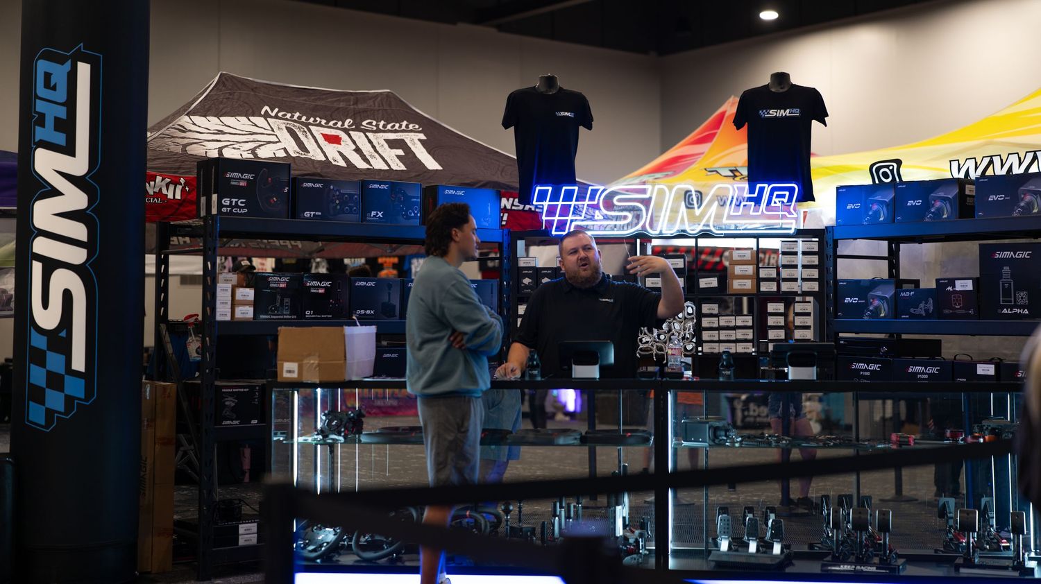 Panoramic view of a modern fitness center interior with equipment and signage.