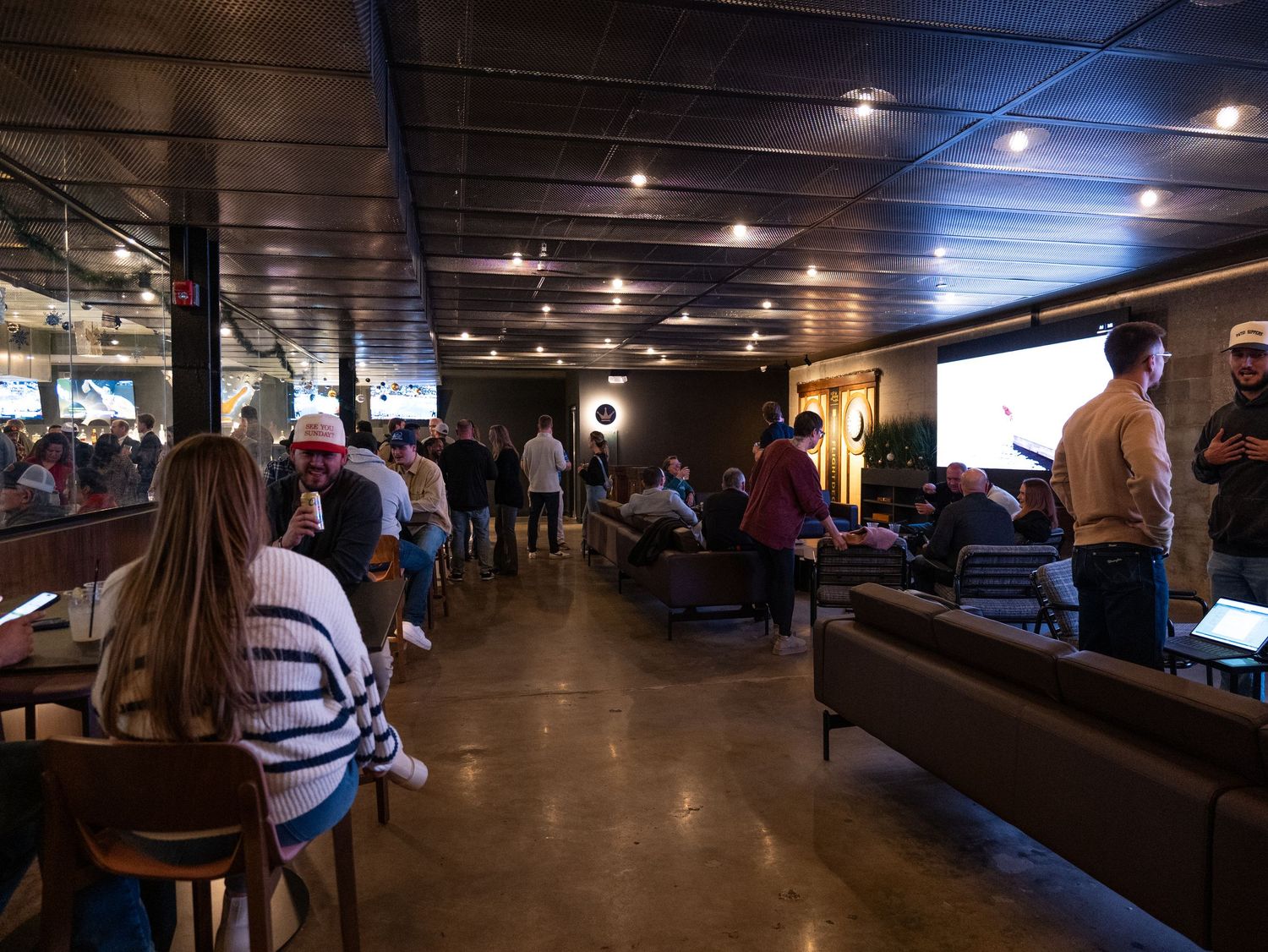Dark interior of a cruise ship corridor with low lighting and wooden paneling along the walls and floor.