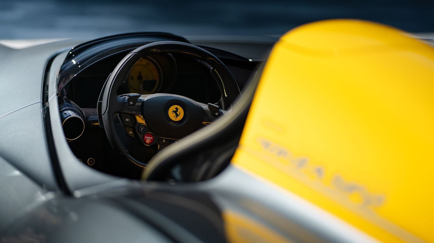 Close-up details of a yellow sports car interior and exterior panels in dramatic lighting.