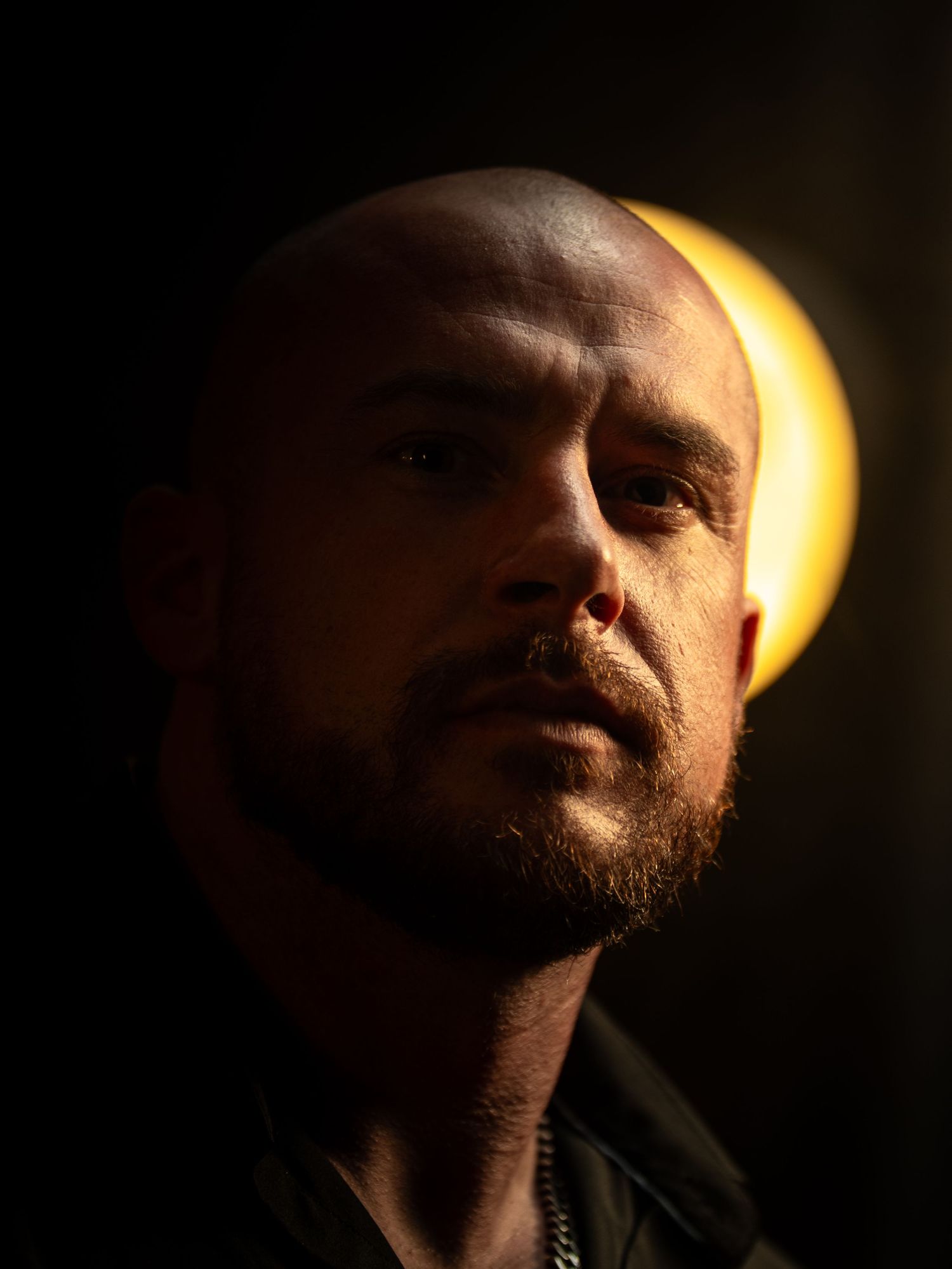 A dramatic portrait sequence showing a face emerging from shadow with striking side lighting creating a moody atmosphere.