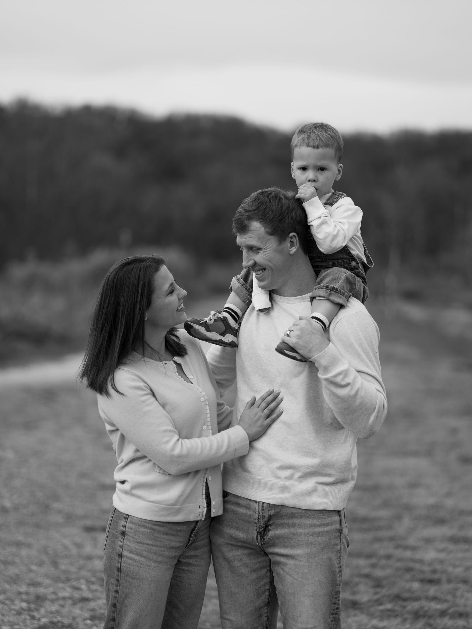 A black and white photo sequence shows a couple playfully interacting and embracing in an outdoor setting.