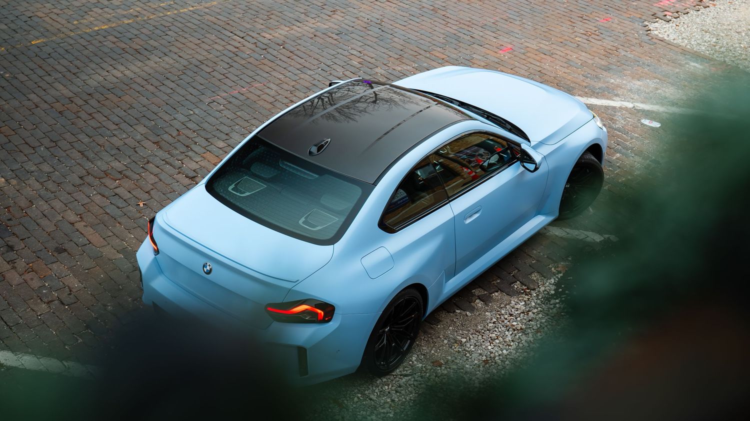 Light blue sports car photographed from multiple low angles showing sleek aerodynamic design.