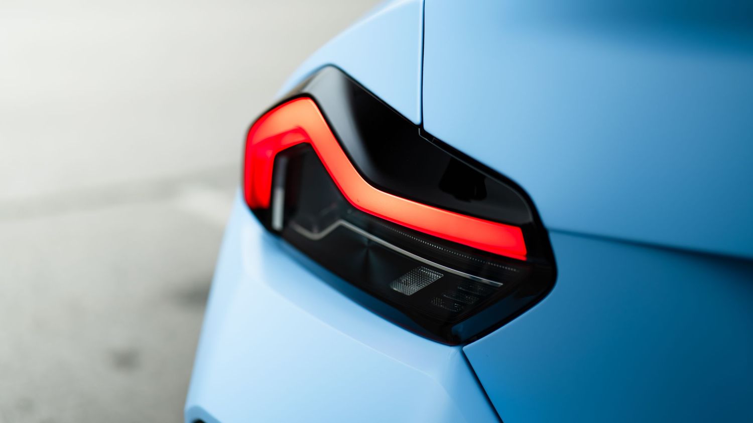 Close-up shots of BMW M2's distinctive blue paint and red taillights.