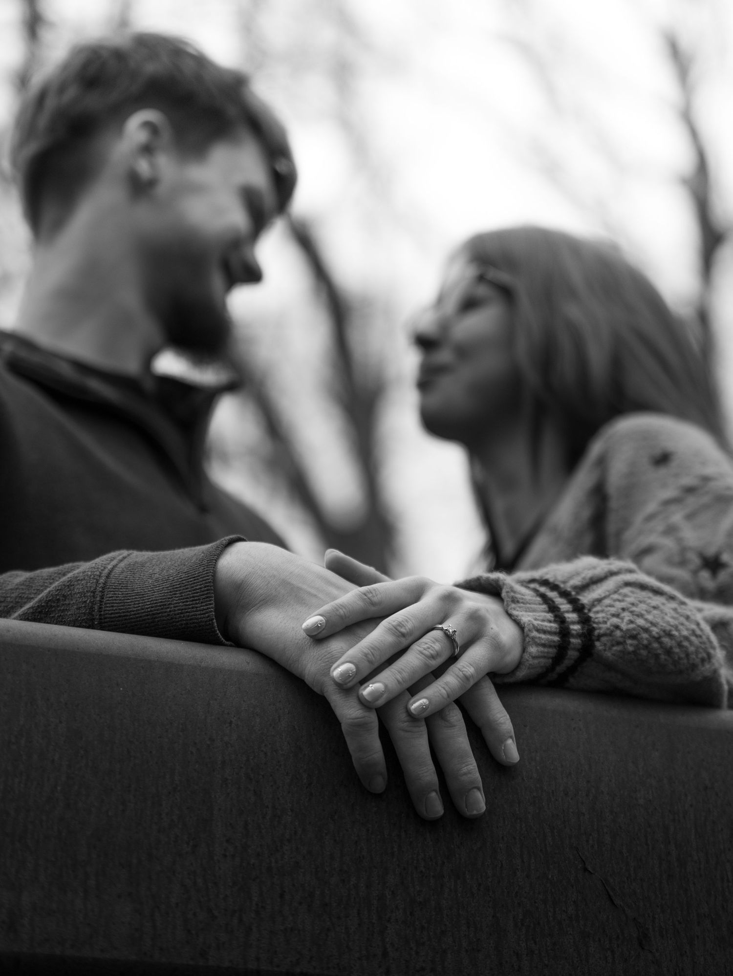 A series of black and white photographs showing hands tenderly touching and embracing in intimate moments.