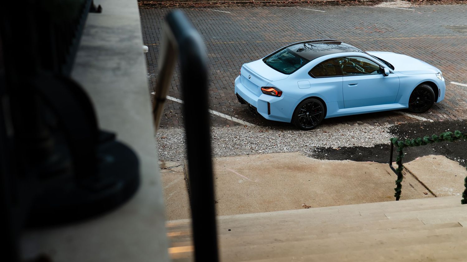 BMW M2 in baby blue color viewed from different angles on a street.