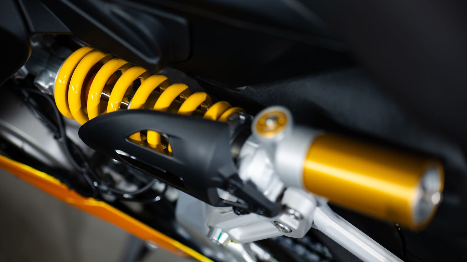 Abstract view of gold motorcycle mechanical parts and fairings.