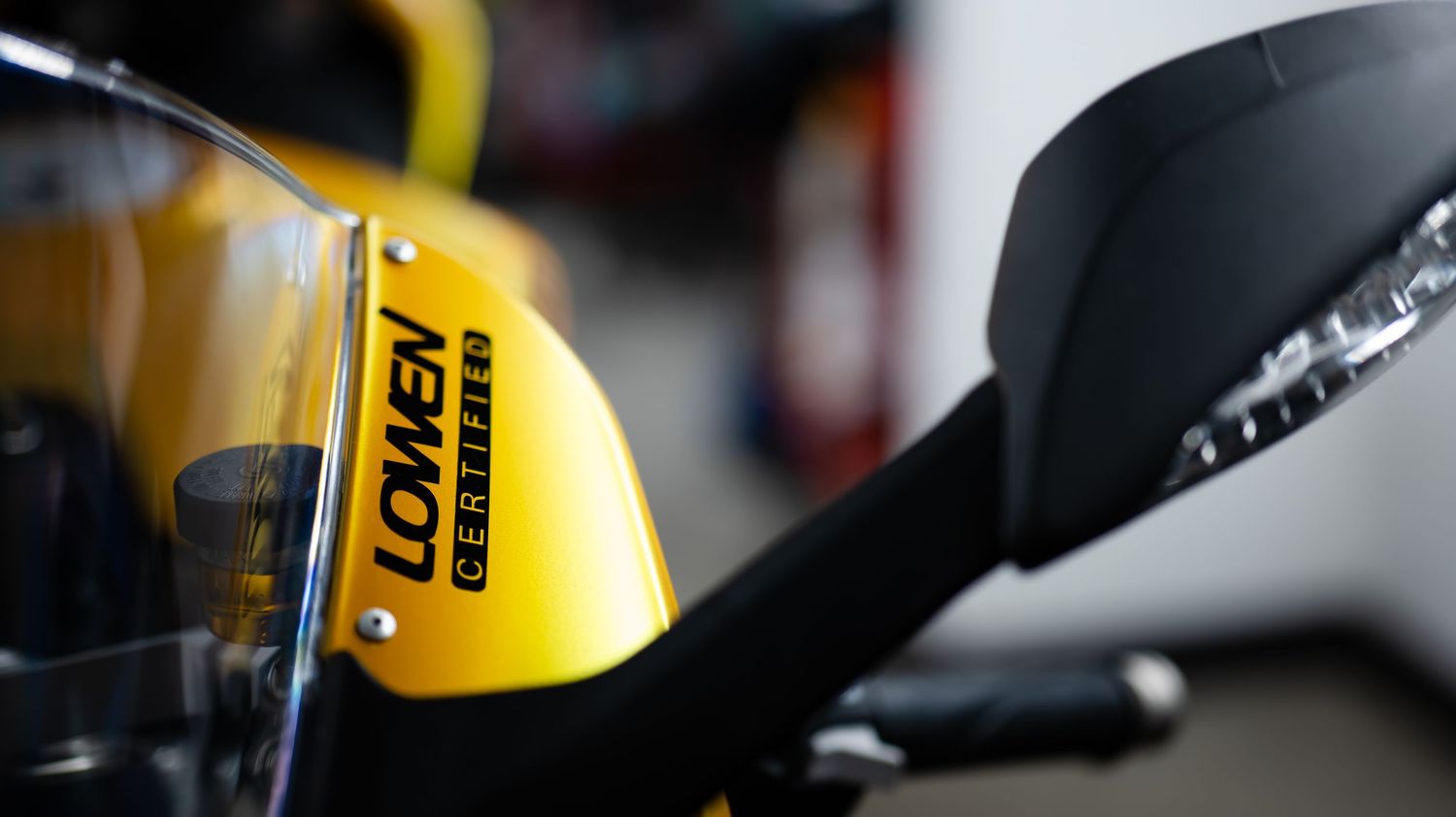 Close-up detail of yellow and black motorcycle components.