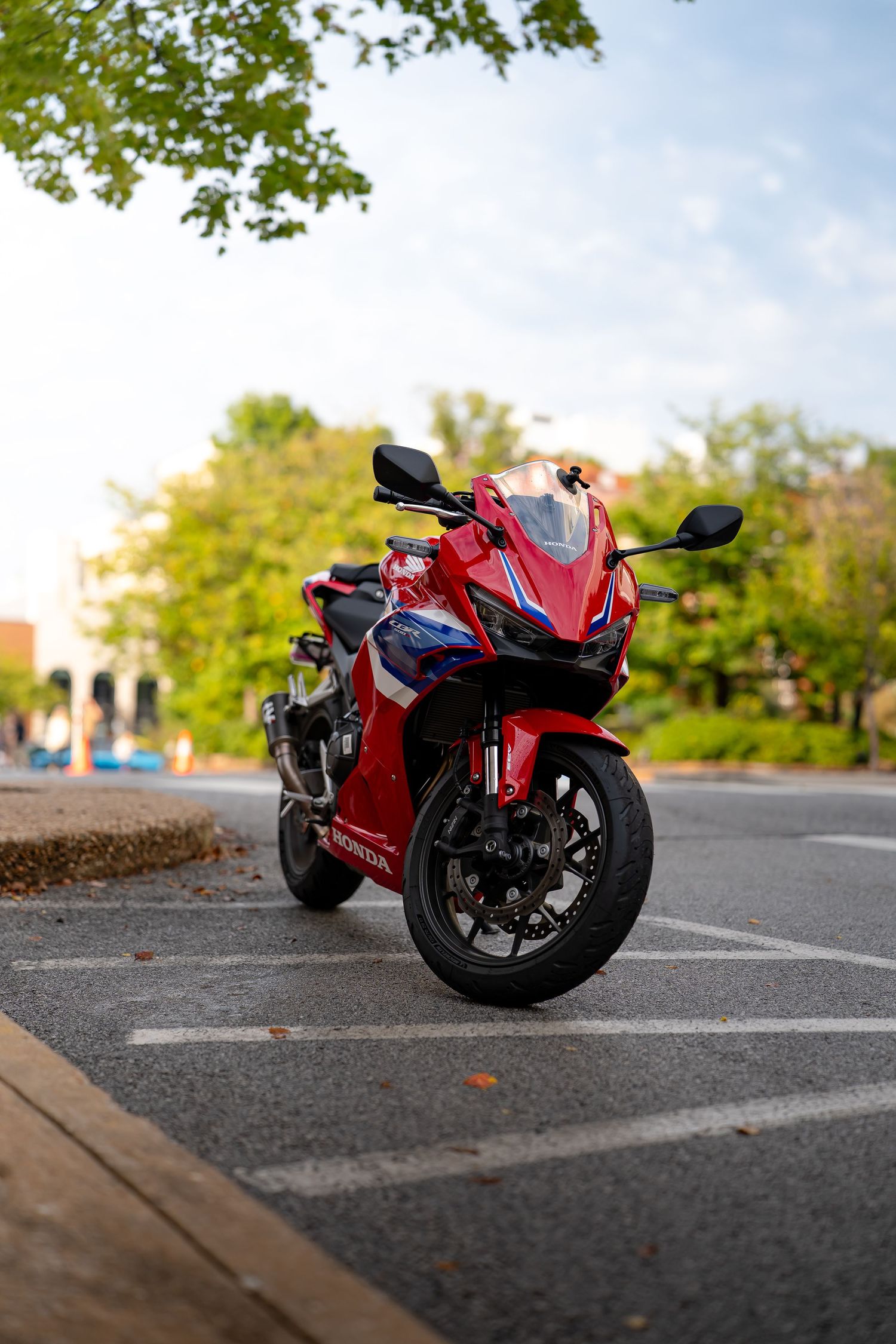 Red Honda CBR motorcycle parked in lot with multiple angles shown.