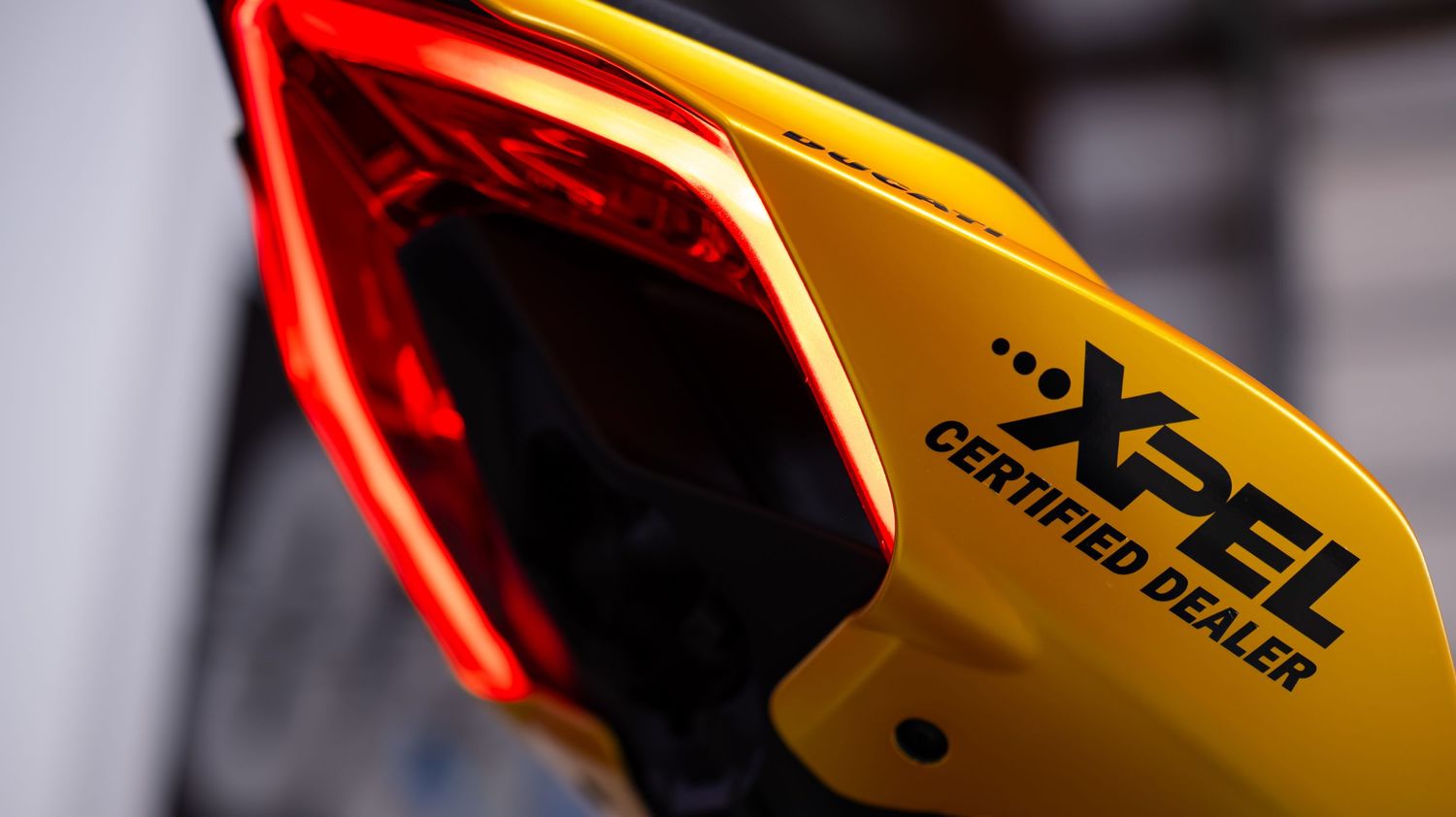 Detail shot of red and yellow motorcycle fairings with bold graphics.