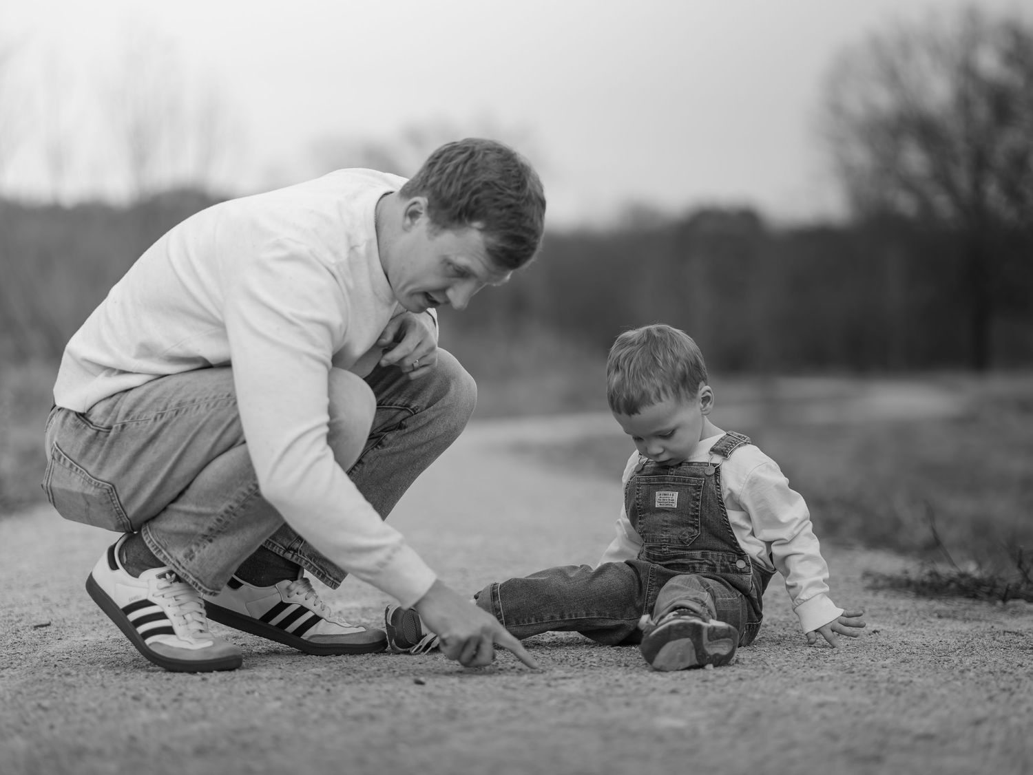 Vintage black and white sequence of a child and adult playing together on the ground.