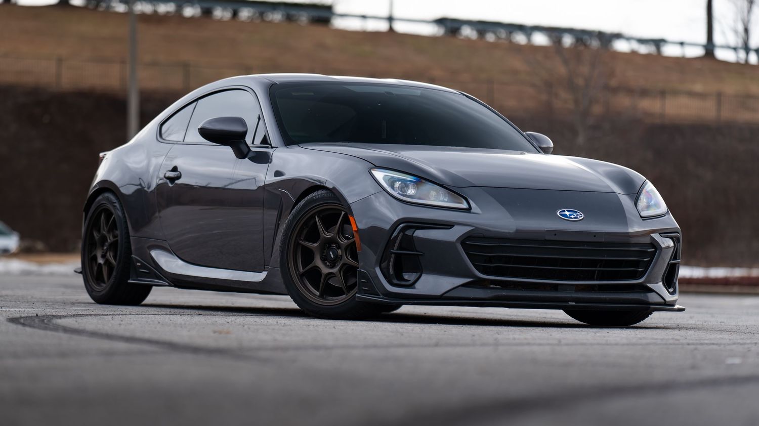Row of gray luxury sports cars photographed from a dramatic low angle.