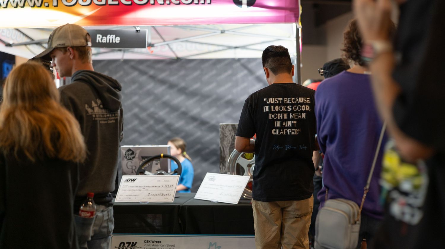 Crowd gathering at an indoor automotive event space.