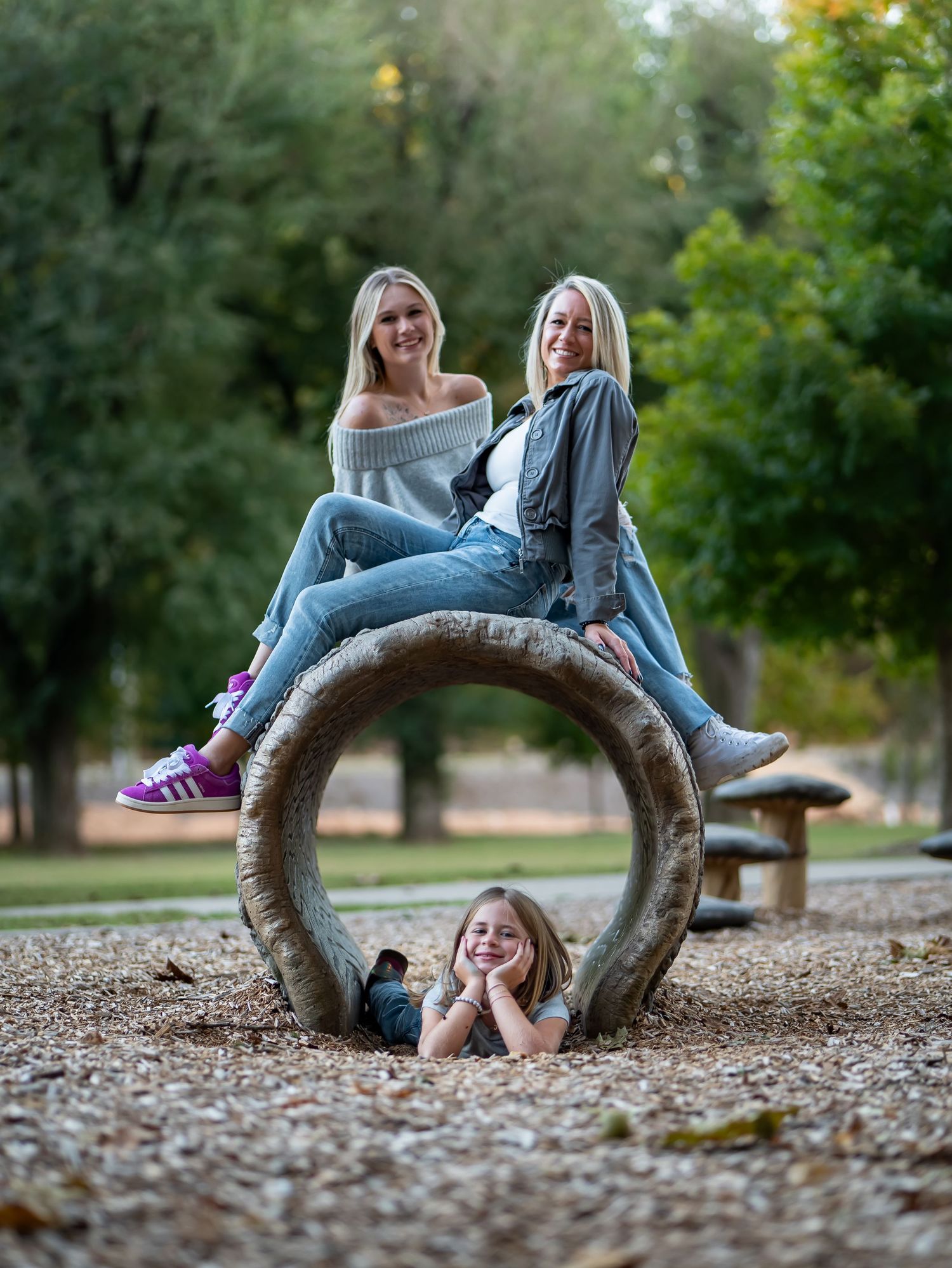 A series of artistic outdoor portrait photos showing someone posing playfully on a curved tree branch in autumn.
