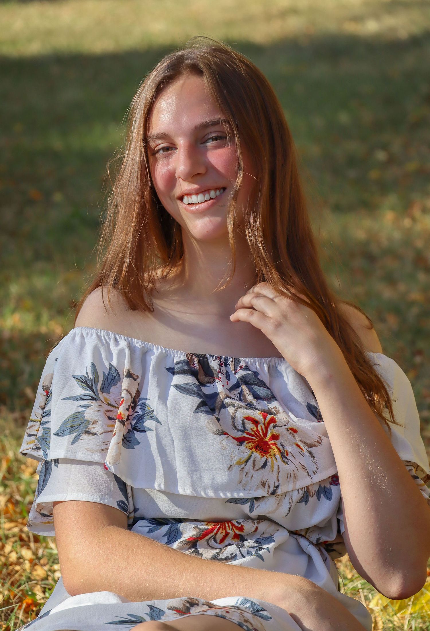 Senior photo of girl. Forest, warm, smiling.