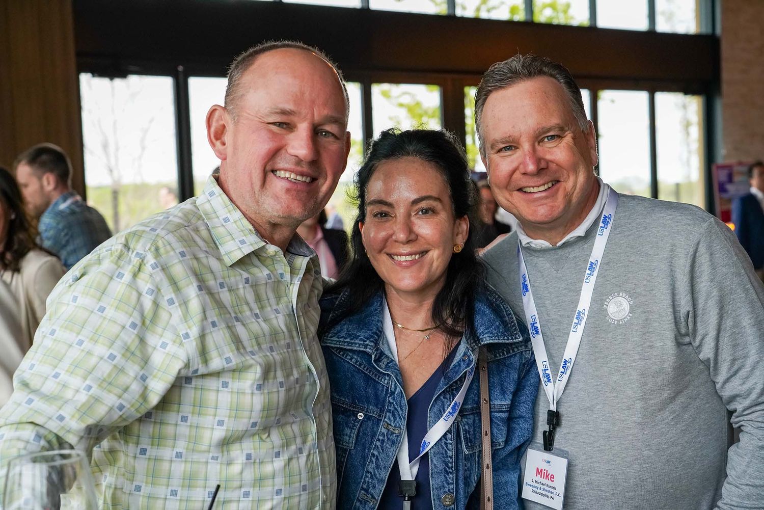 Business professionals networking and socializing at an indoor corporate event.