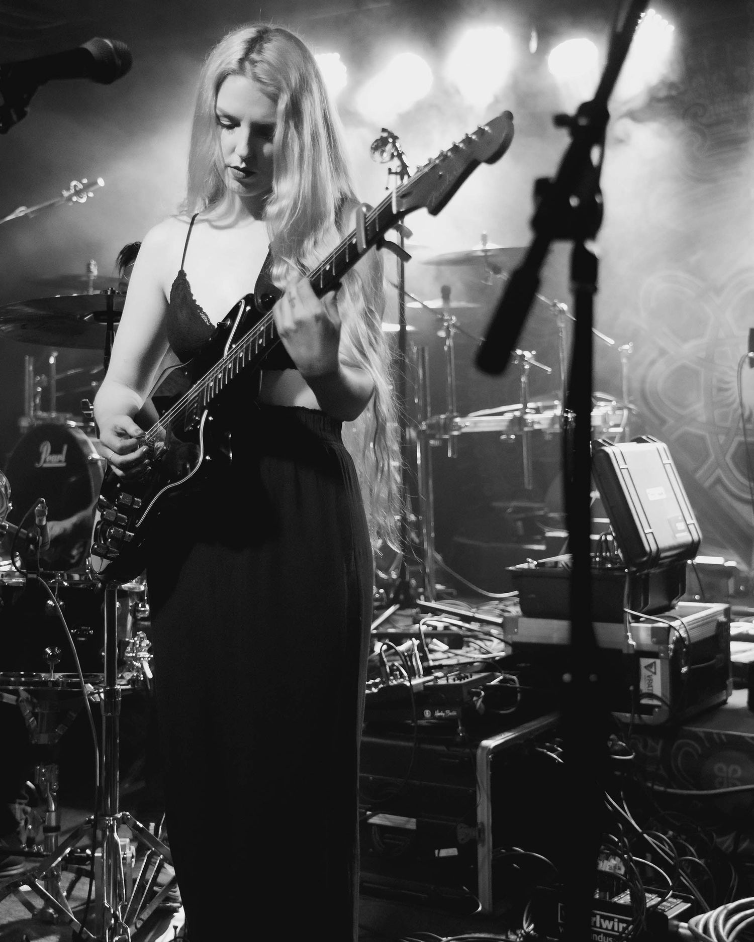 Black and white concert photography showing musicians performing with instruments.