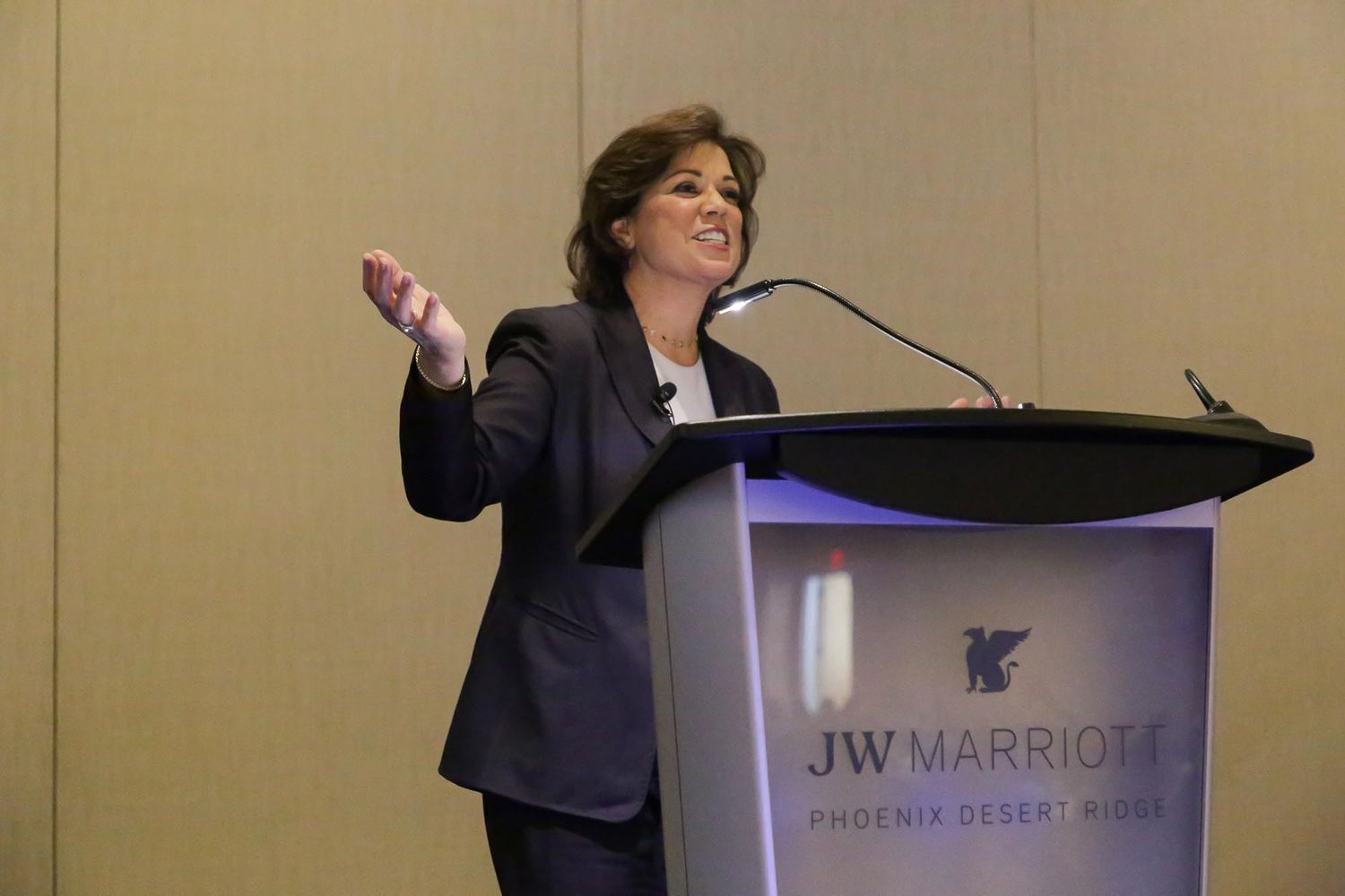Speaker giving a presentation at a podium during a corporate event at JW Marriott.