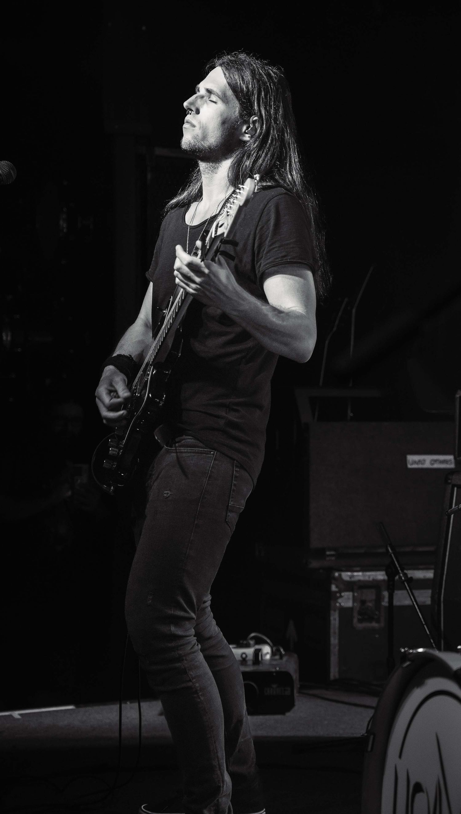 Black and white photo of a musician performing passionately on stage.