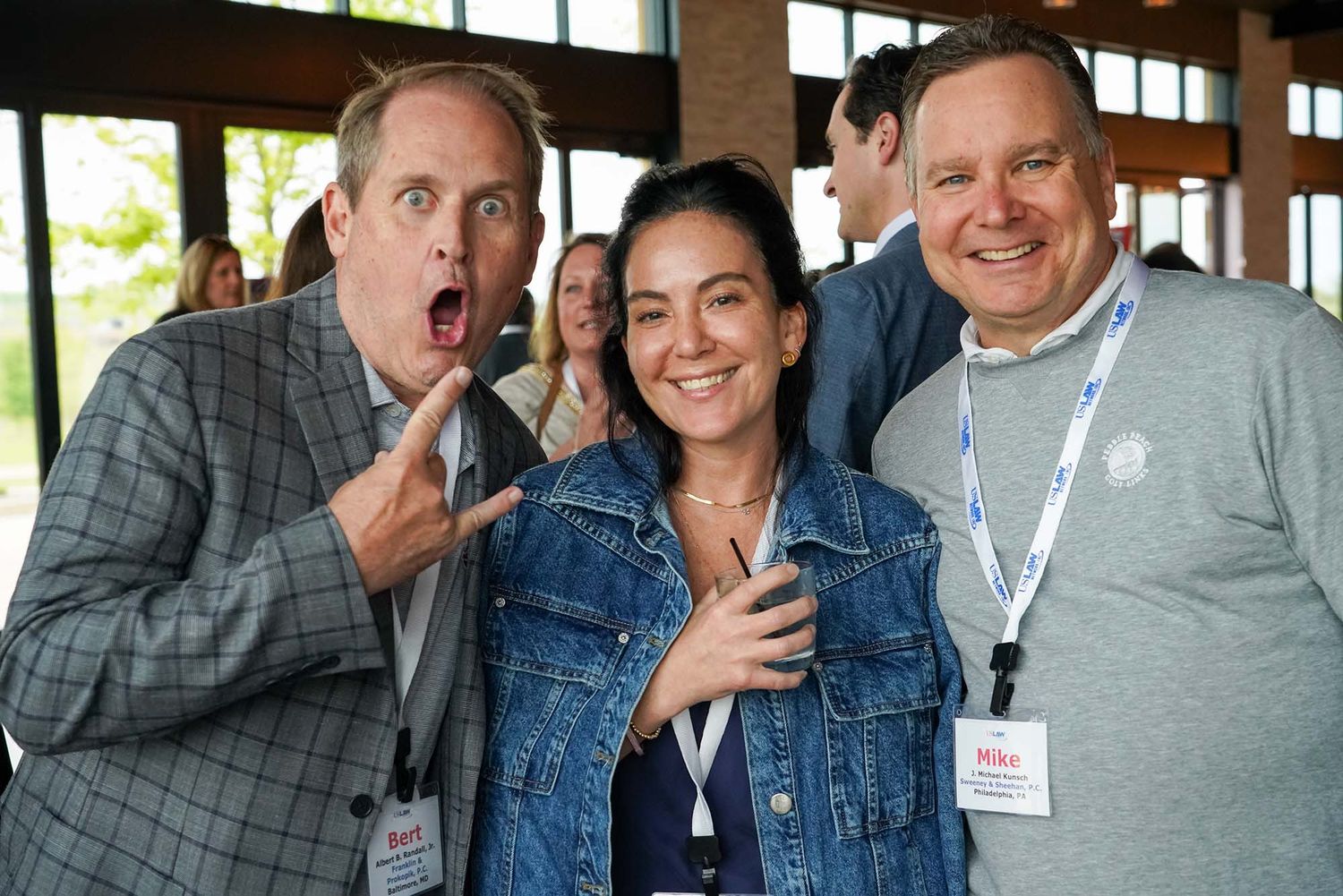 Colleagues sharing laughs and conversations during a professional gathering.