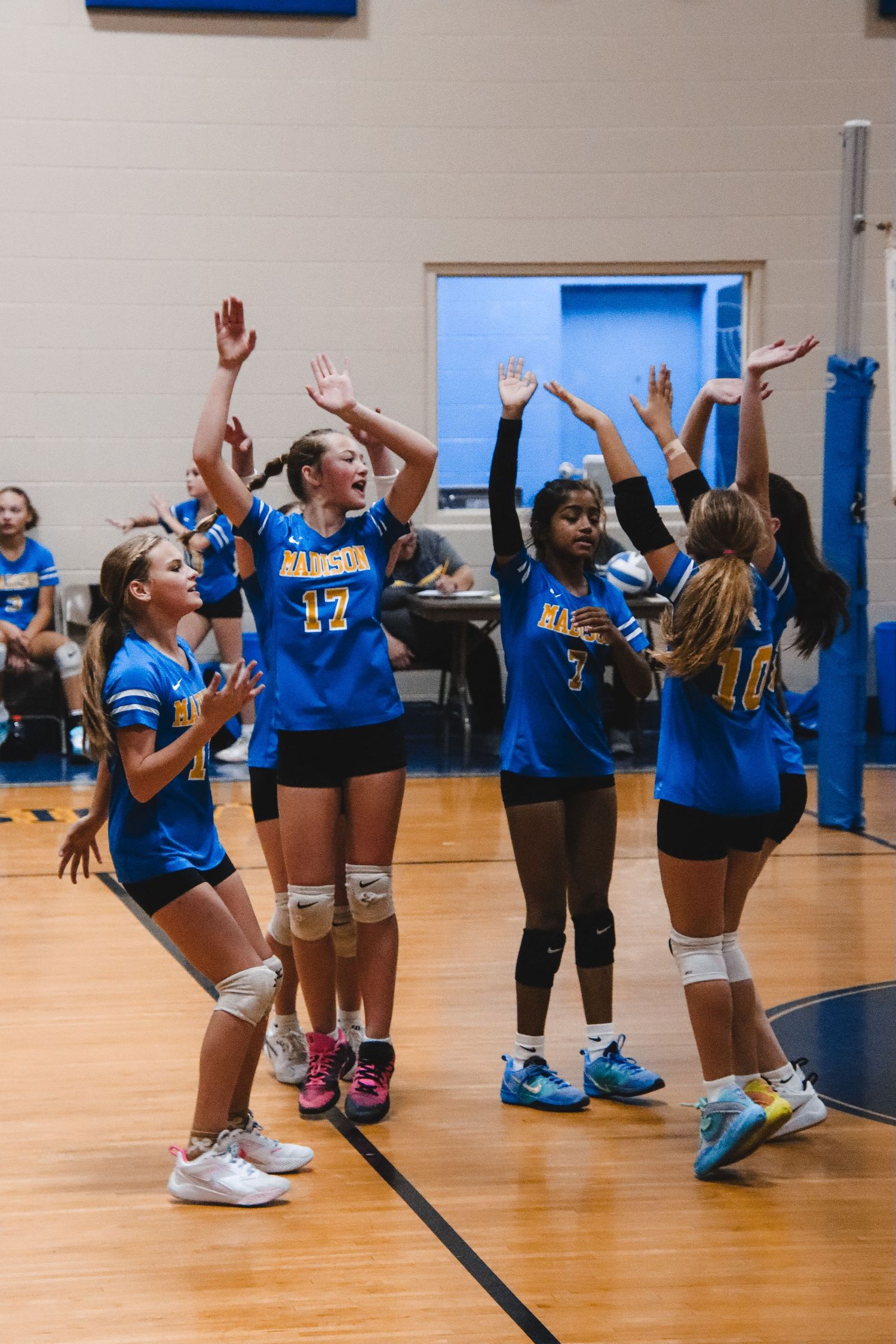 Team celebrating by jumping up.