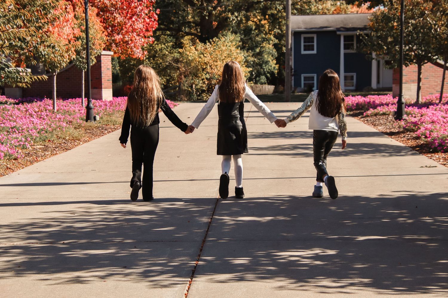 Three sisters holding hands.
