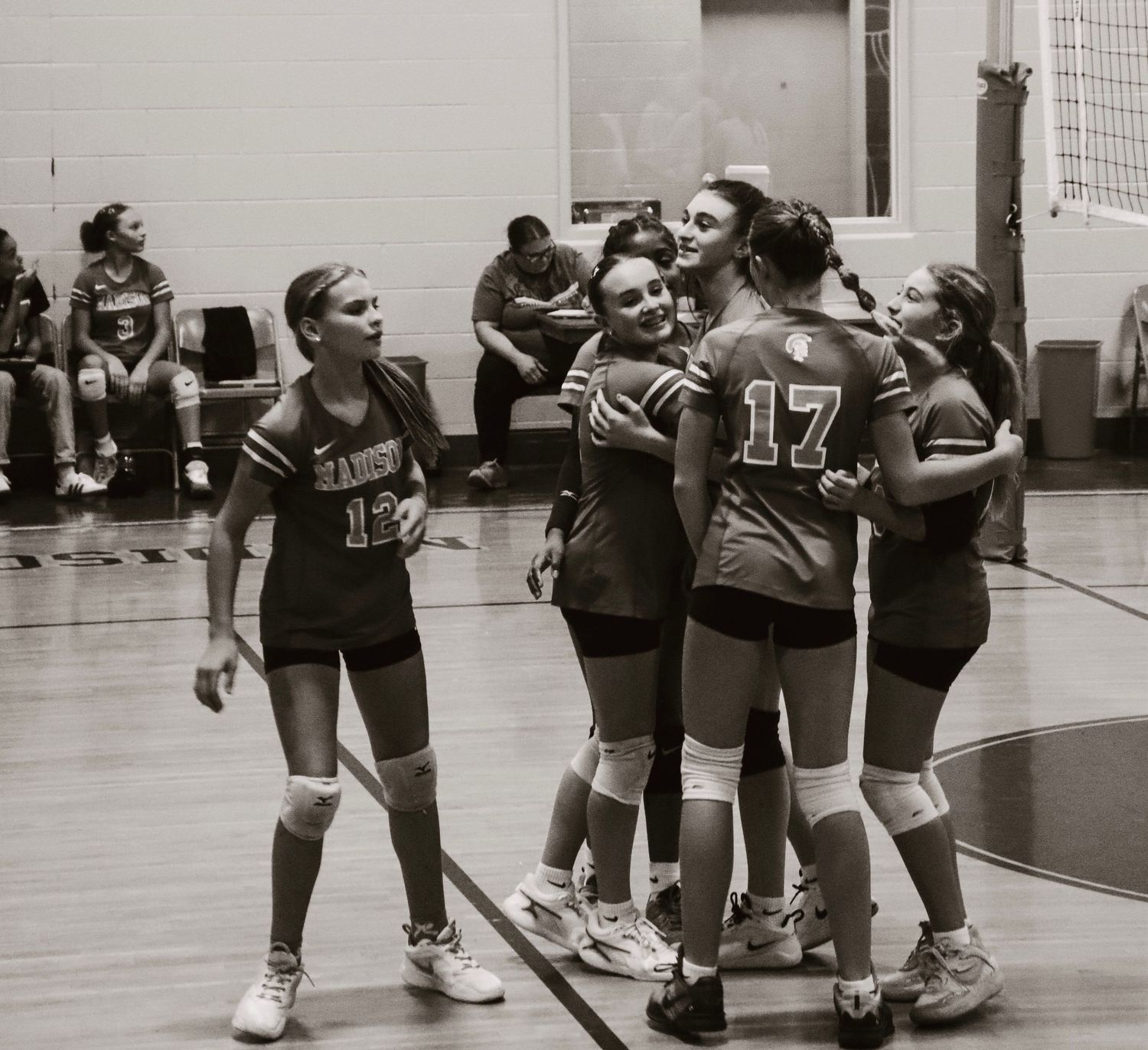 Team celebrating in black and white.