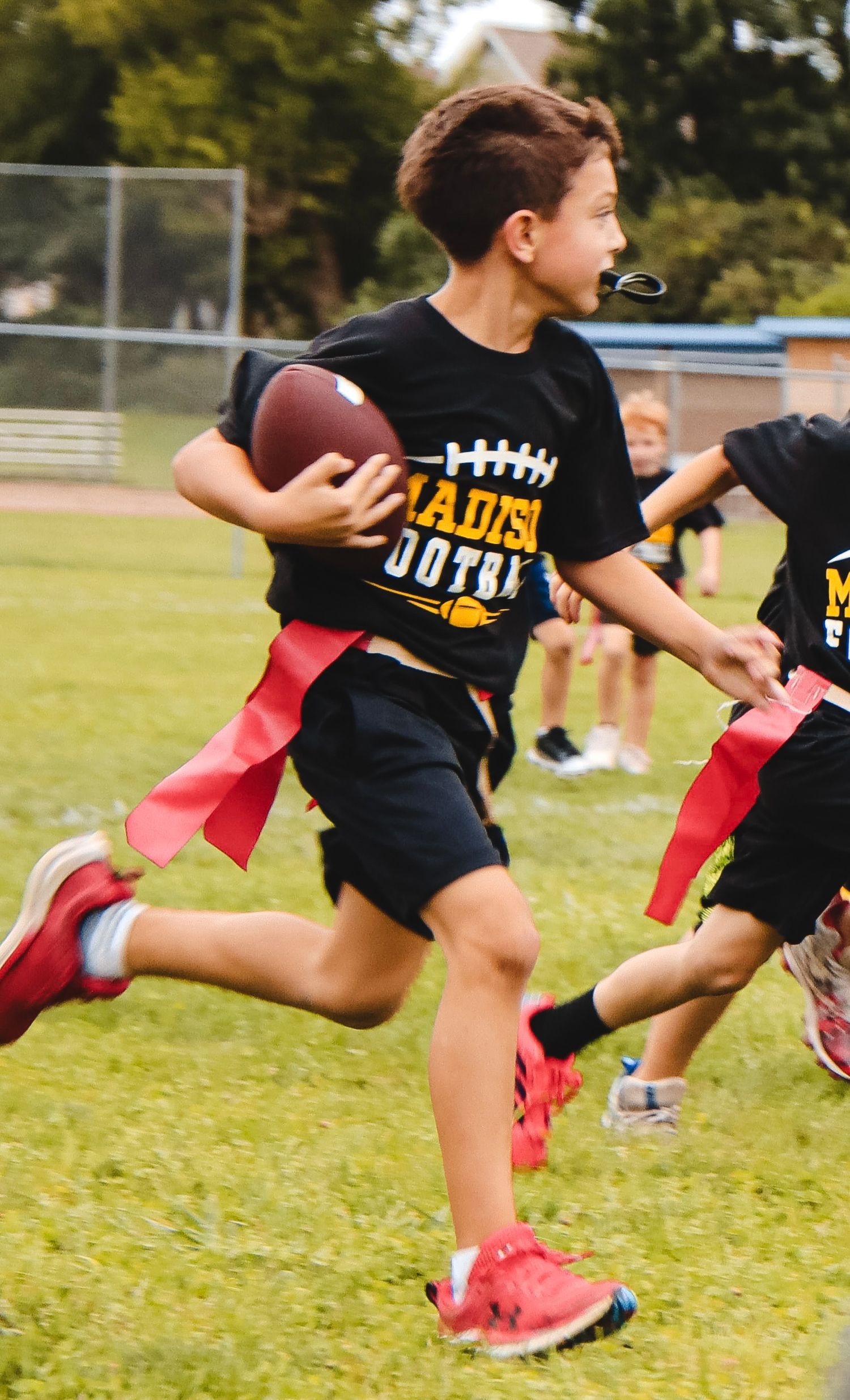 Running the football to end zone in flag football.