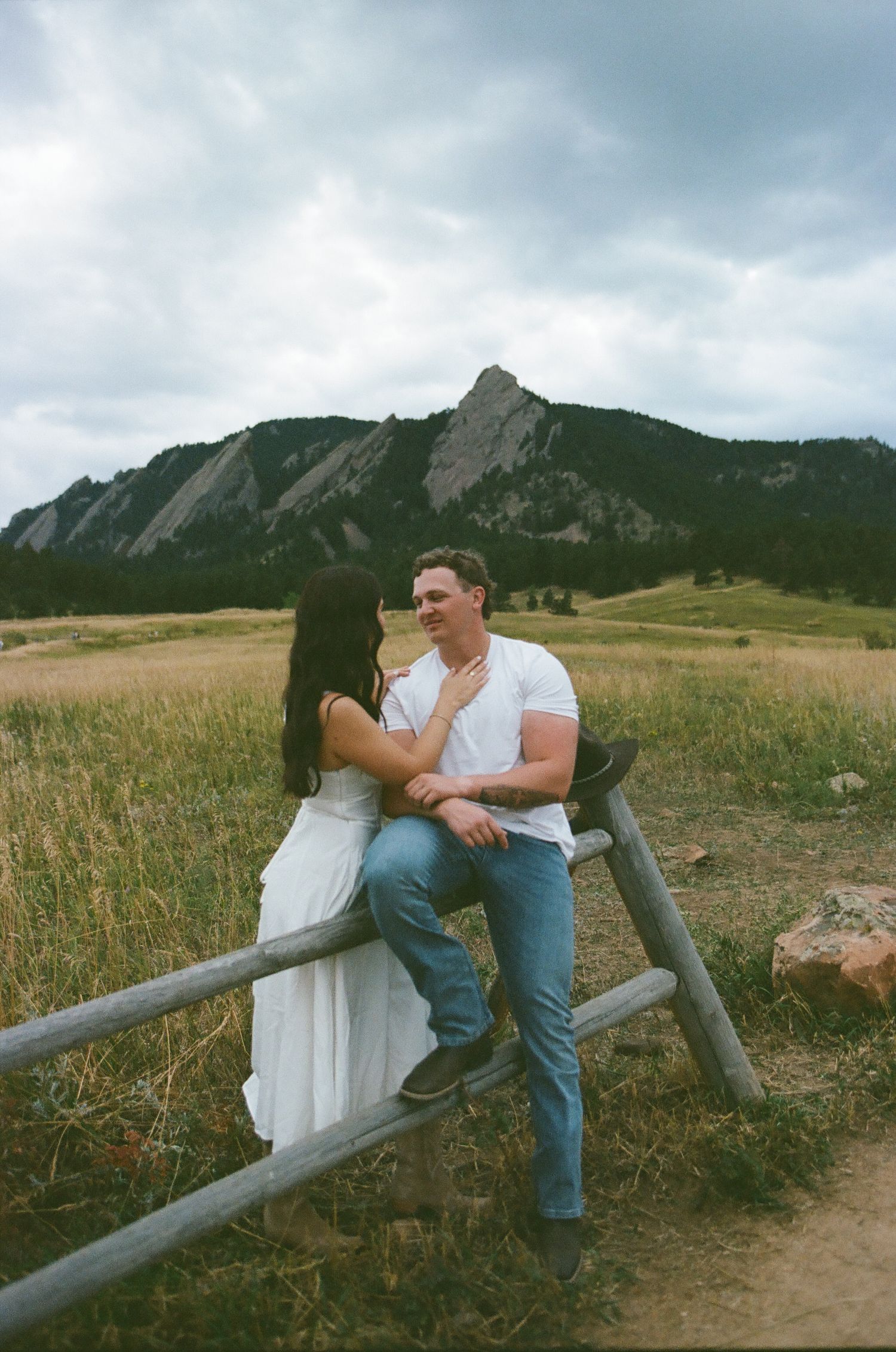 Engagement portrait in a grassy field in Boulder Colorado.