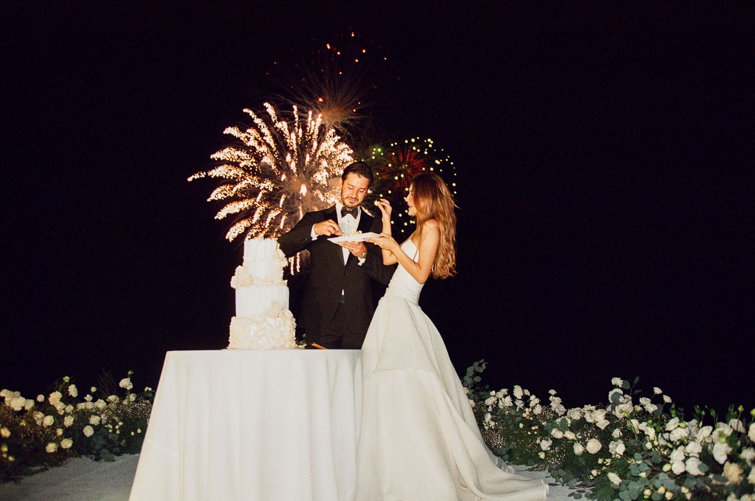 Newlyweds during cake cutting in Cabo San Lucas Mexico