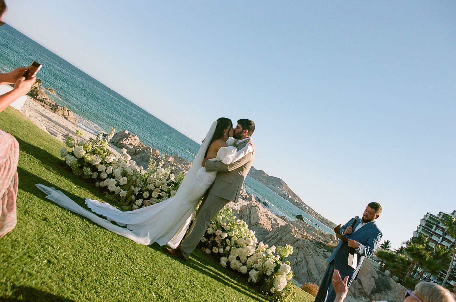 Newlyweds kissing during ceremony at Mar del Cabo.