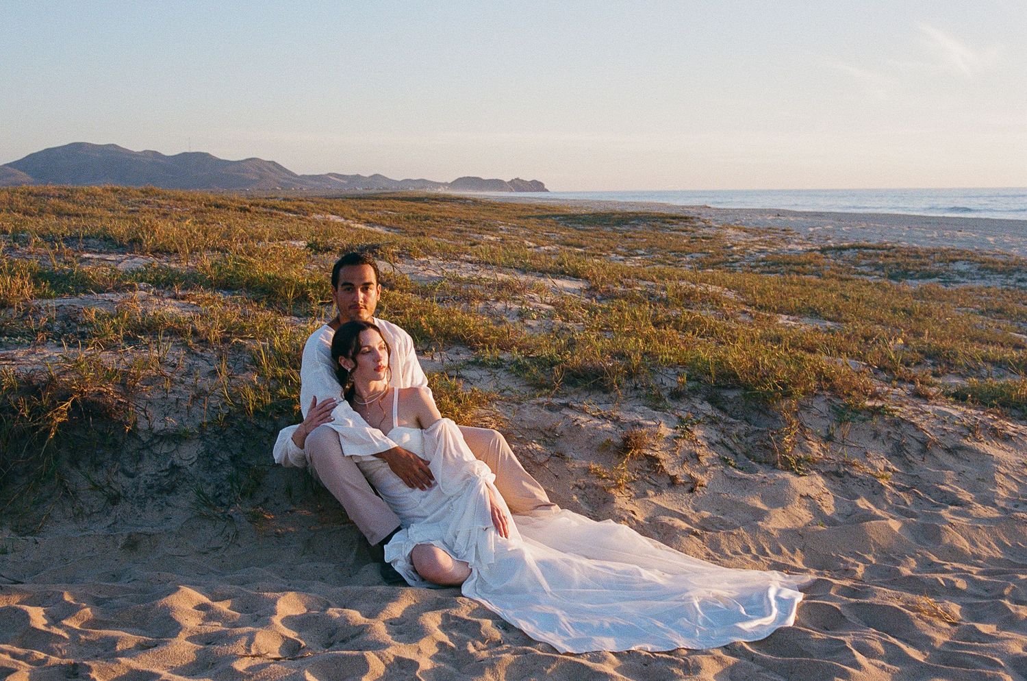 Editorial and romantic portrait of newlyweds on desert beach in Todos Santos.