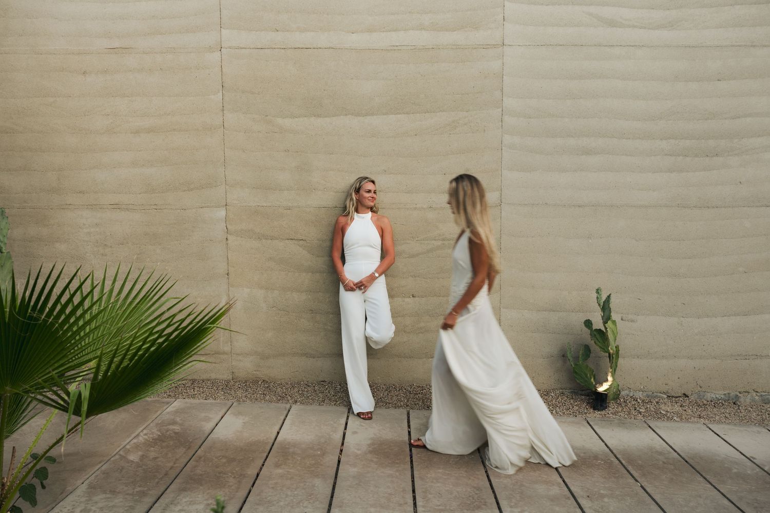 Editorial engagement portrait photographed against a concrete wall at Acre Resort.