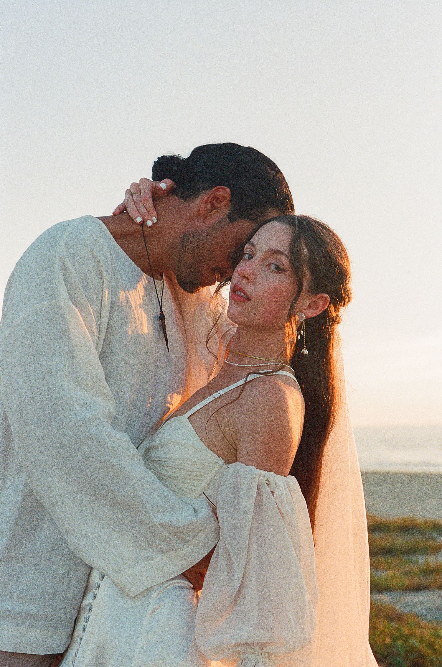 Editorial, romantic photo of couple embracing during sunset on the beach after elopement in Todos Santos.