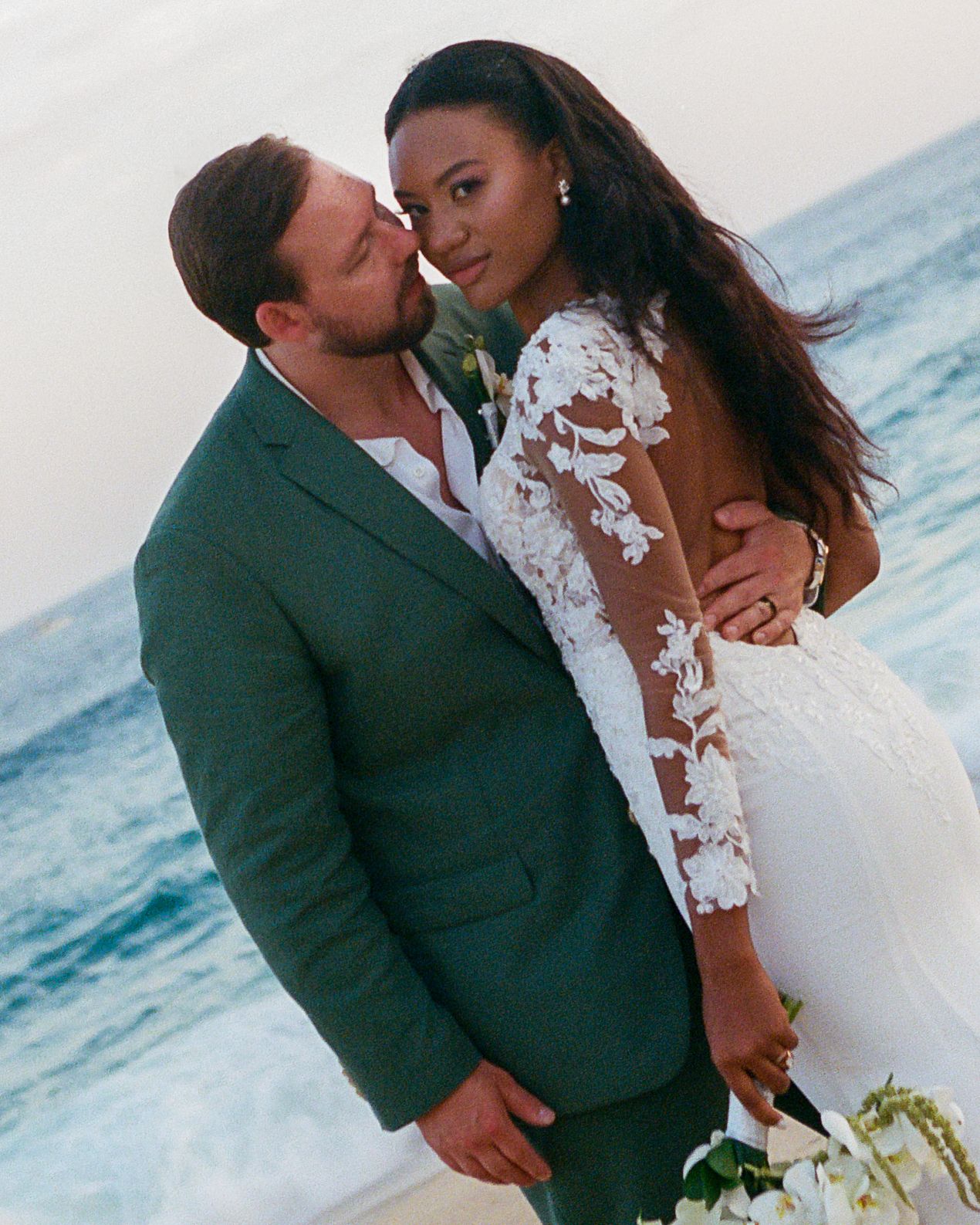 Editorial portrait of newlyweds embracing.