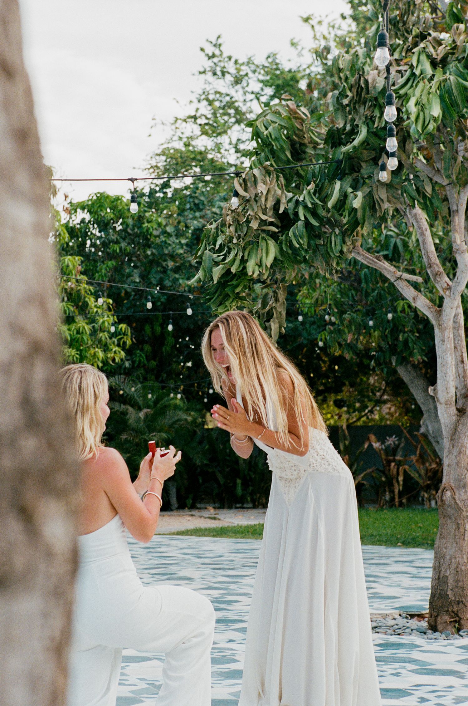 Moment of proposal with fiancé smiling big at Acre Los Cabos.