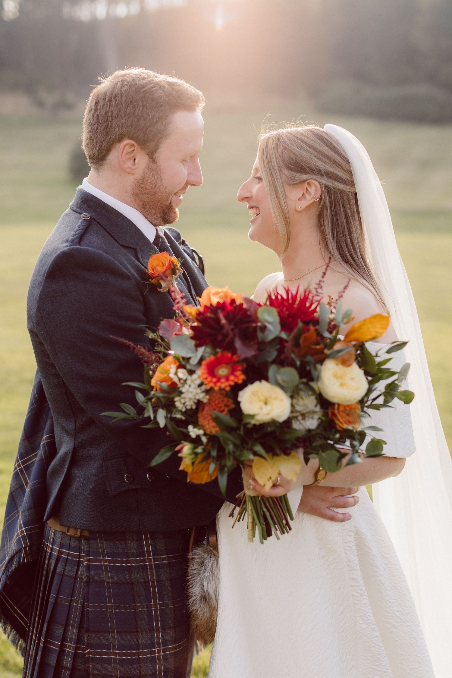 A romantic wedding photo series showing a couple in traditional Scottish attire with vibrant autumn floral bouquets.