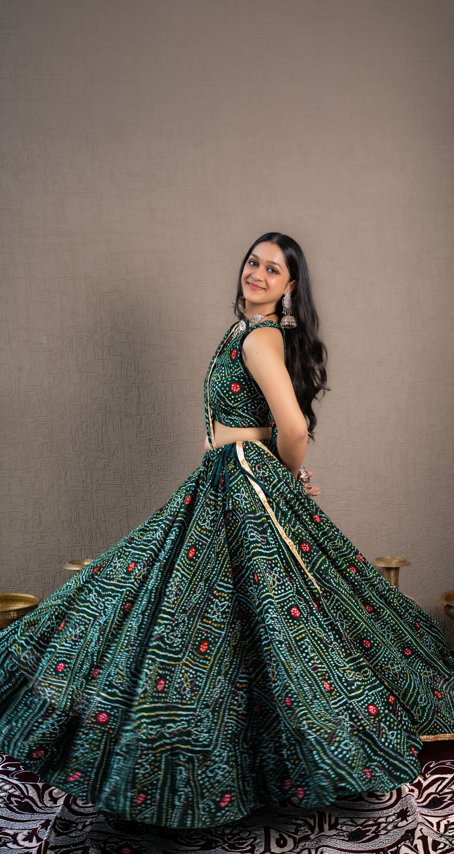 Editorial portrait of a model wearing a handcrafted Gujarati Chaniya Choli with detailed embroidery and mirror work.