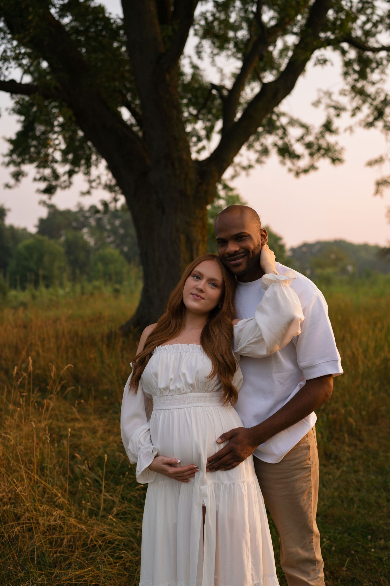 Expectant parents holding one another during their maternity session.