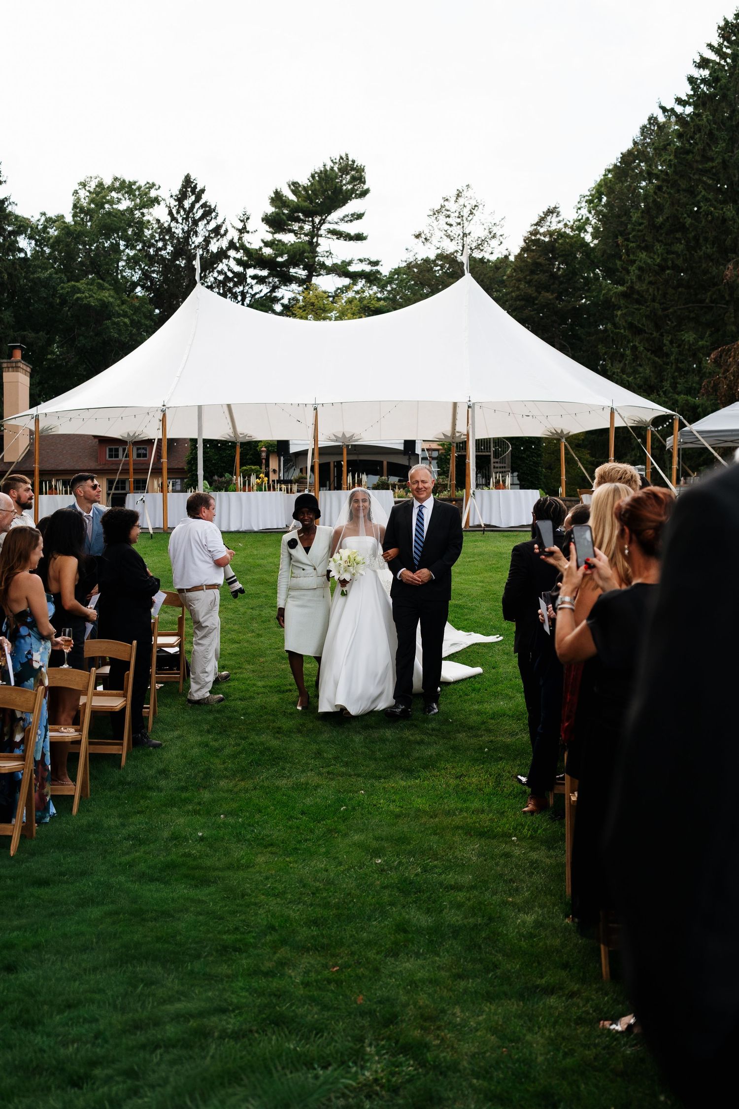 Bride and groom walking hand in hand across the grounds of Marigold Lodge.