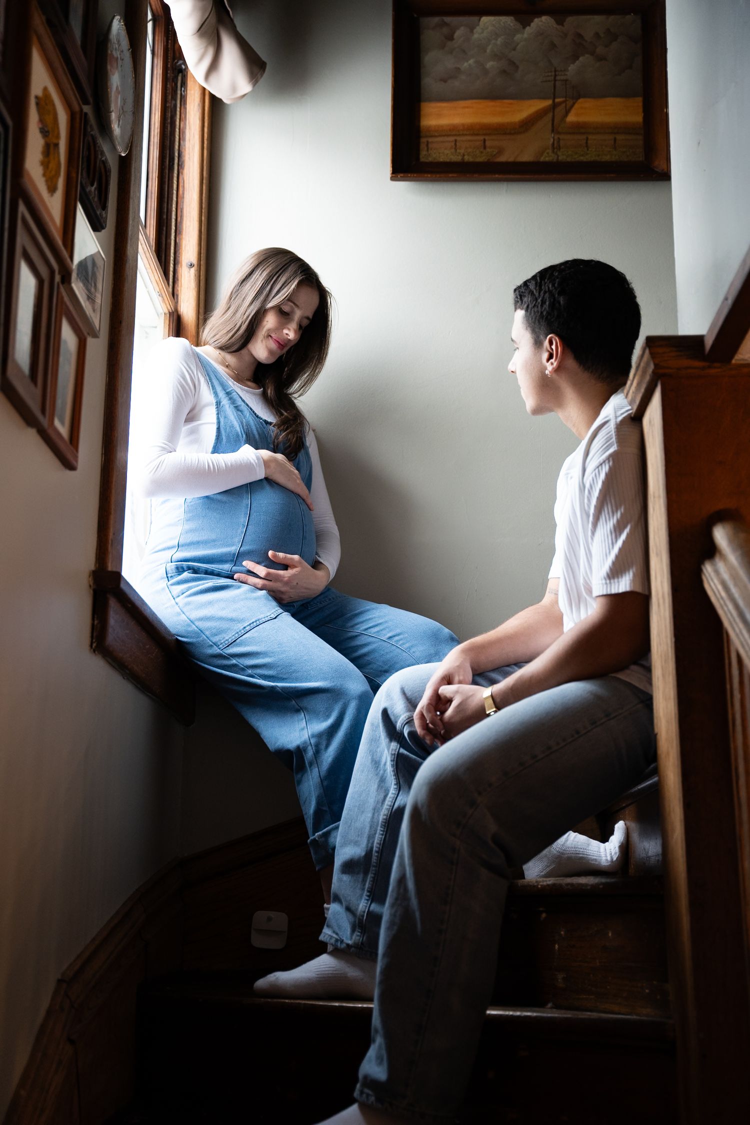 Expectant parents embracing during an intimate maternity session in Allendale, Michigan.