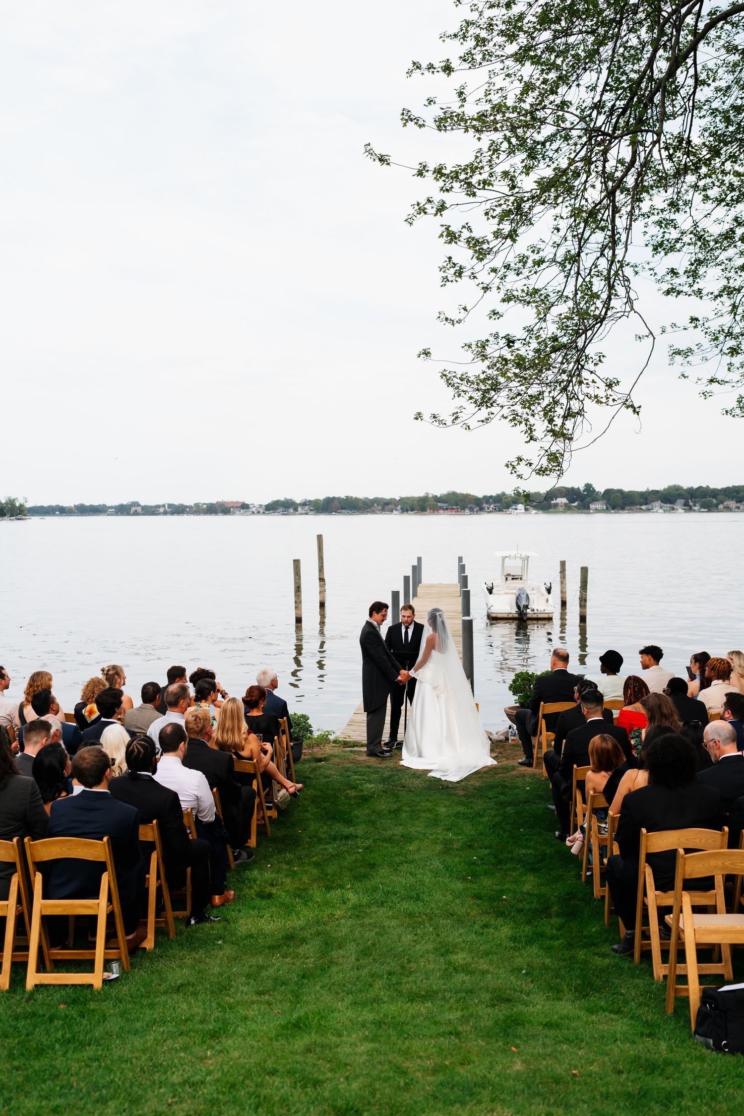 Bride and groom celebrating their wedding day beneath the trees at Marigold Lodge.