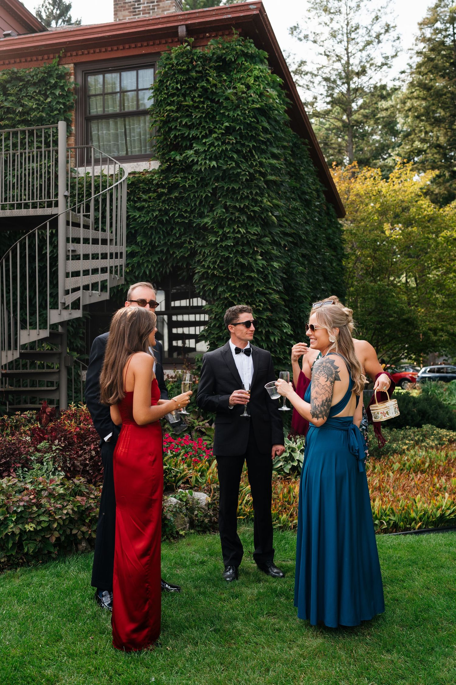 Friends gathering before a private estate ceremony party on Lake Michigan outside of Marigold Lodge.