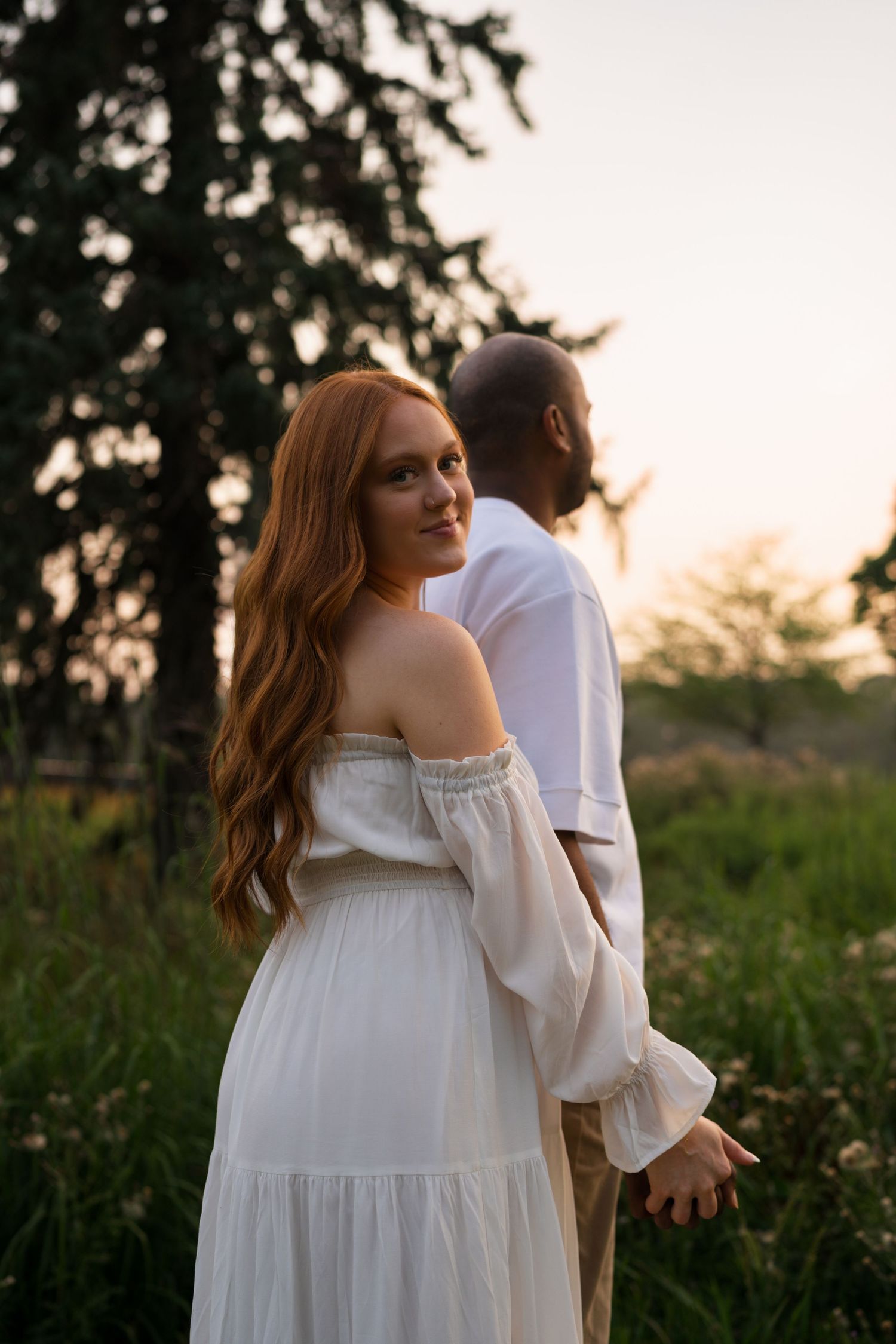 Expectant mother smiling during her maternity session at Highlands Prairie.