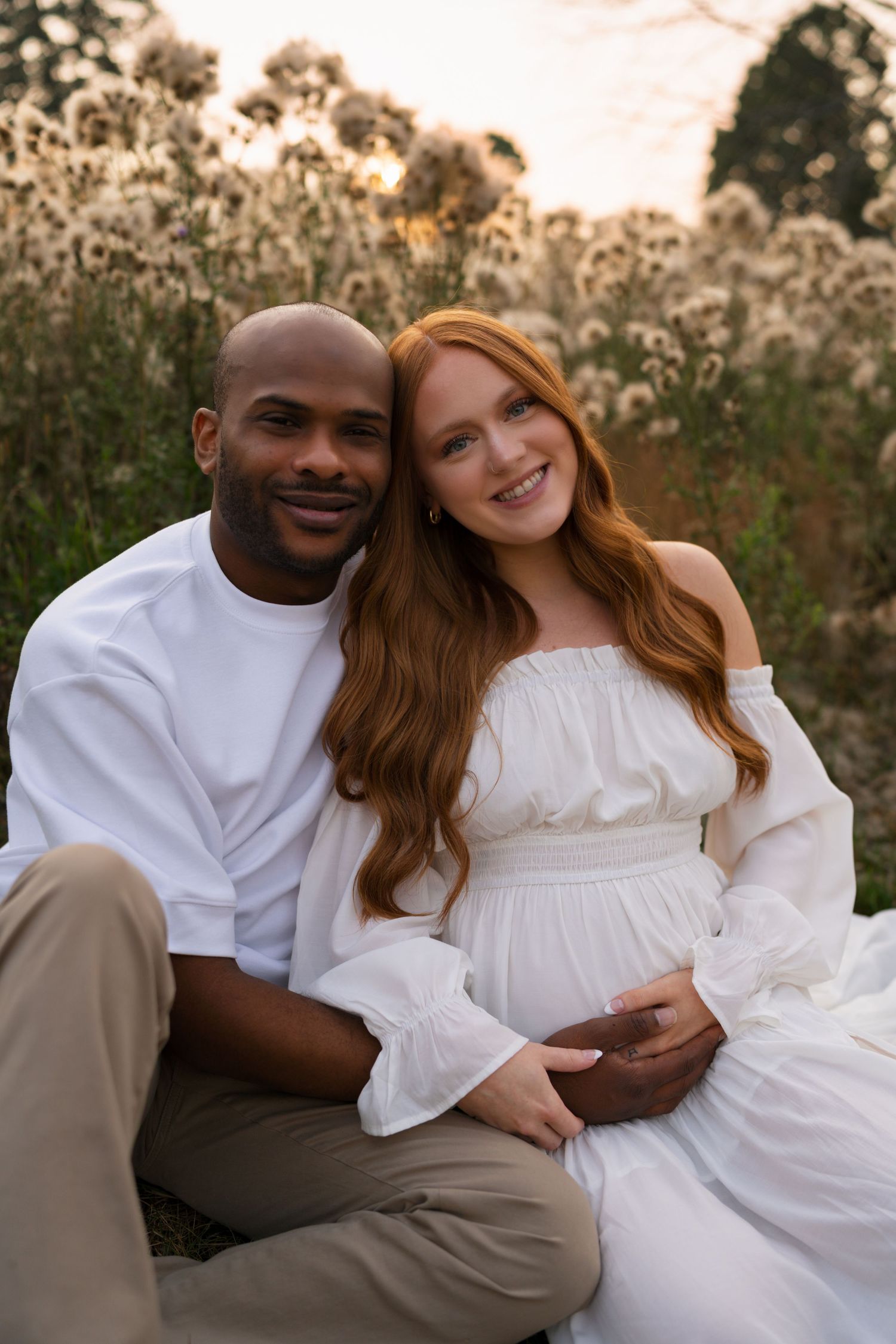 Expectant parents smiling together as they await their growing family at Highlands Prairie.