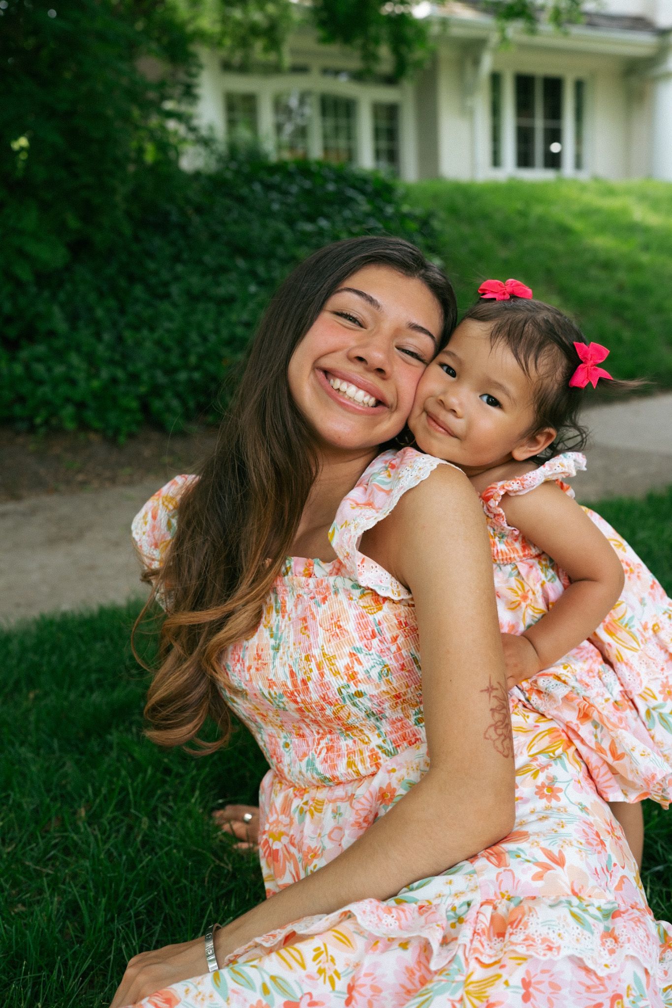 Mother smiling while holding a young child, reflecting the warmth, joy, and connection that inspire photographer Mariah Rosalinda & Co.